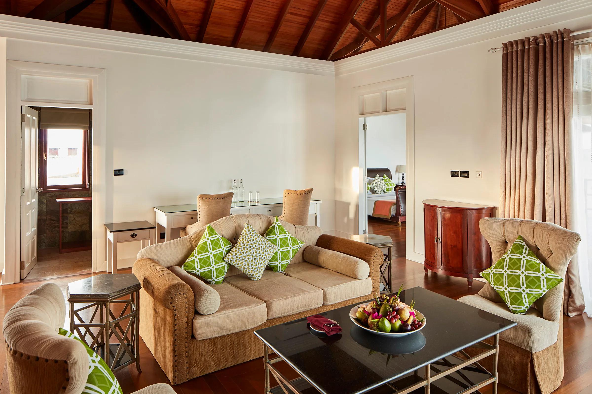 Living area of the Presidential Water Suite at Sun Siyam Olhuveli, opening onto the overwater deck