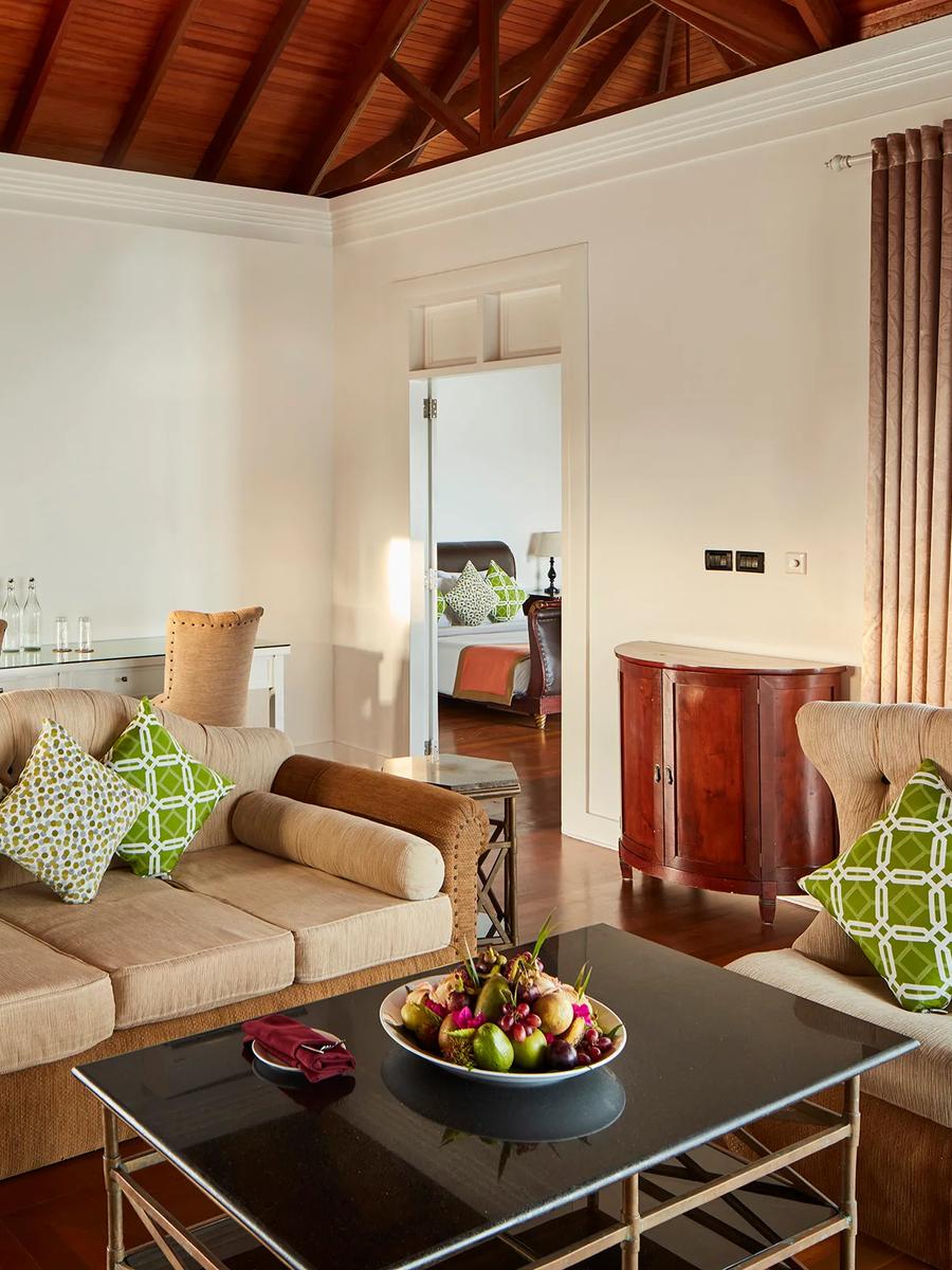 Living area of the Presidential Water Suite at Sun Siyam Olhuveli, opening onto the overwater deck