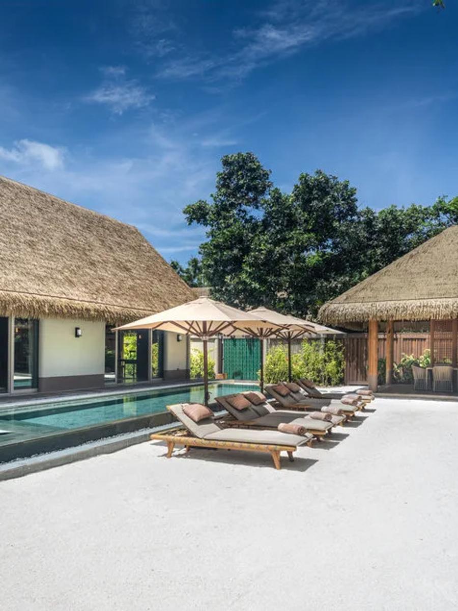 The Three Bedroom Beach Residence with Pool, its long pool running between the main pavilion and a second thatched-roof lounge