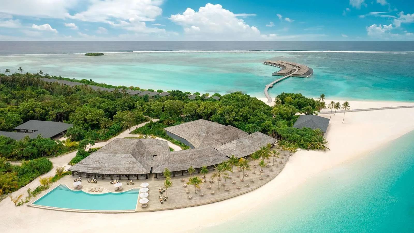 Aerial view of Jawakara's Mabin Island pool deck and restaurant pavilion, with a jetty leading out to a cluster of overwater villas
