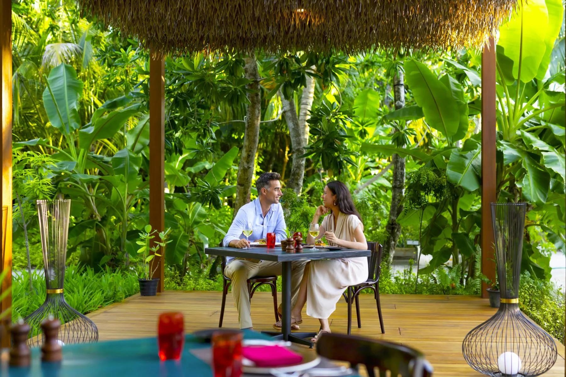 A couple seated at Phat Chameleon, the resort's plant-forward restaurant