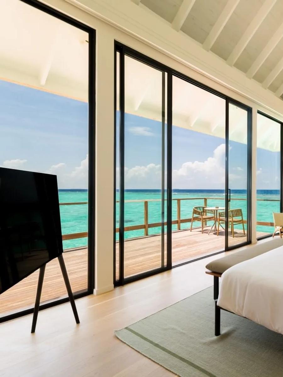 An overwater bedroom with sea view, representative of the 3-Bedroom Water Residence category
