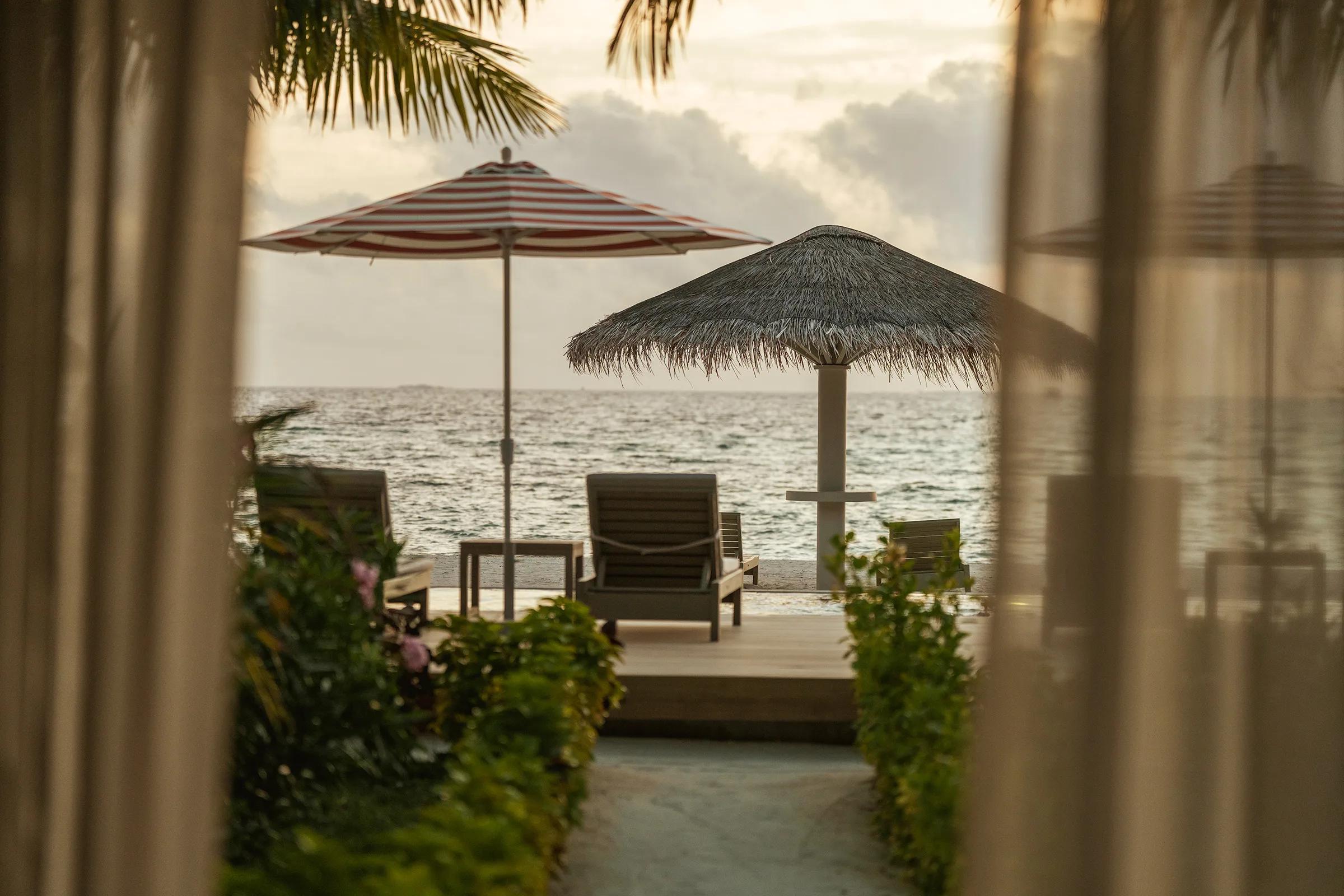 The terrace of a Sunset Beach Pavilion on Main Island, facing the beach and lagoon