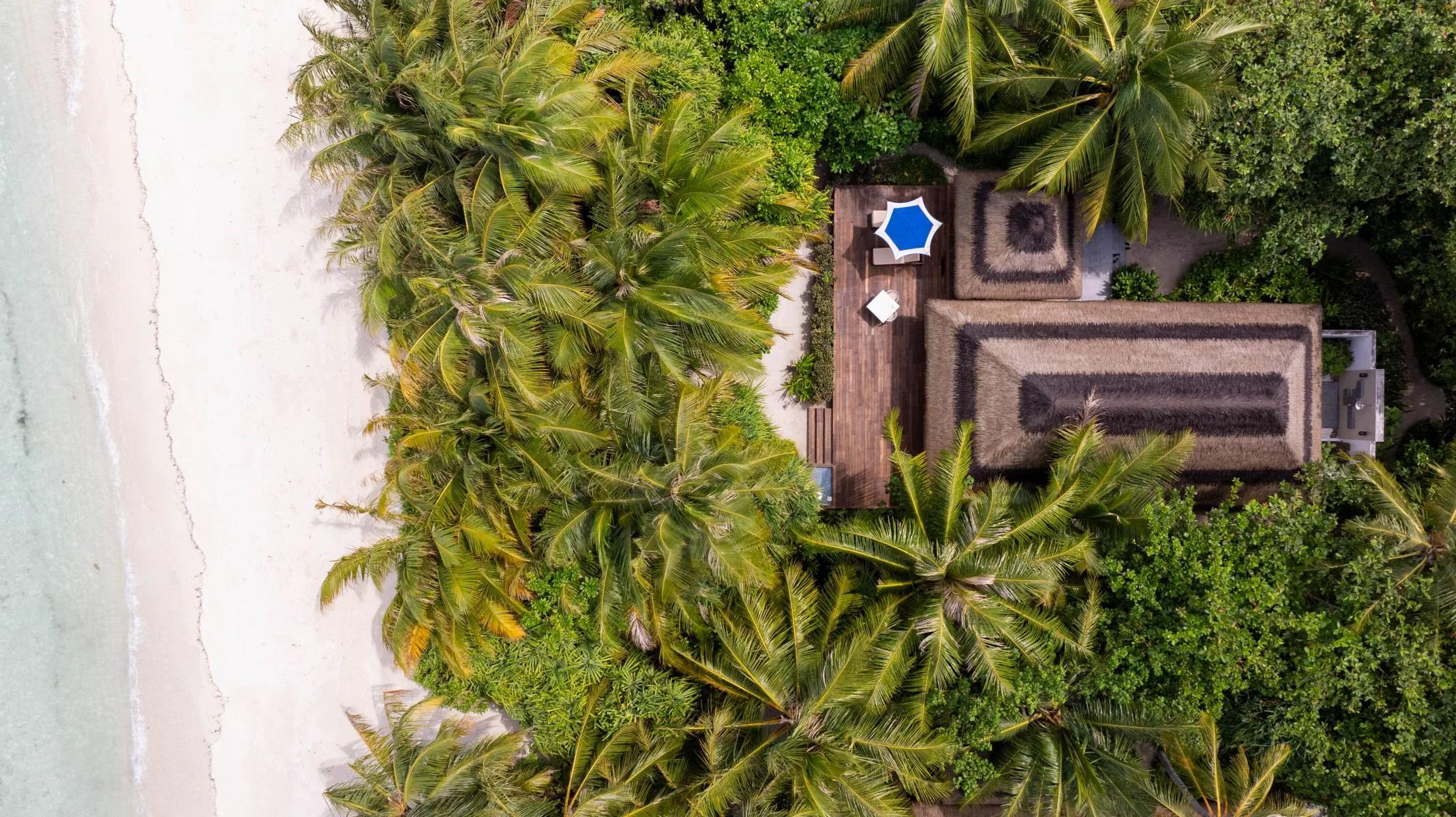 The private terrace of a Beach Villa with a garden pathway toward the ocean