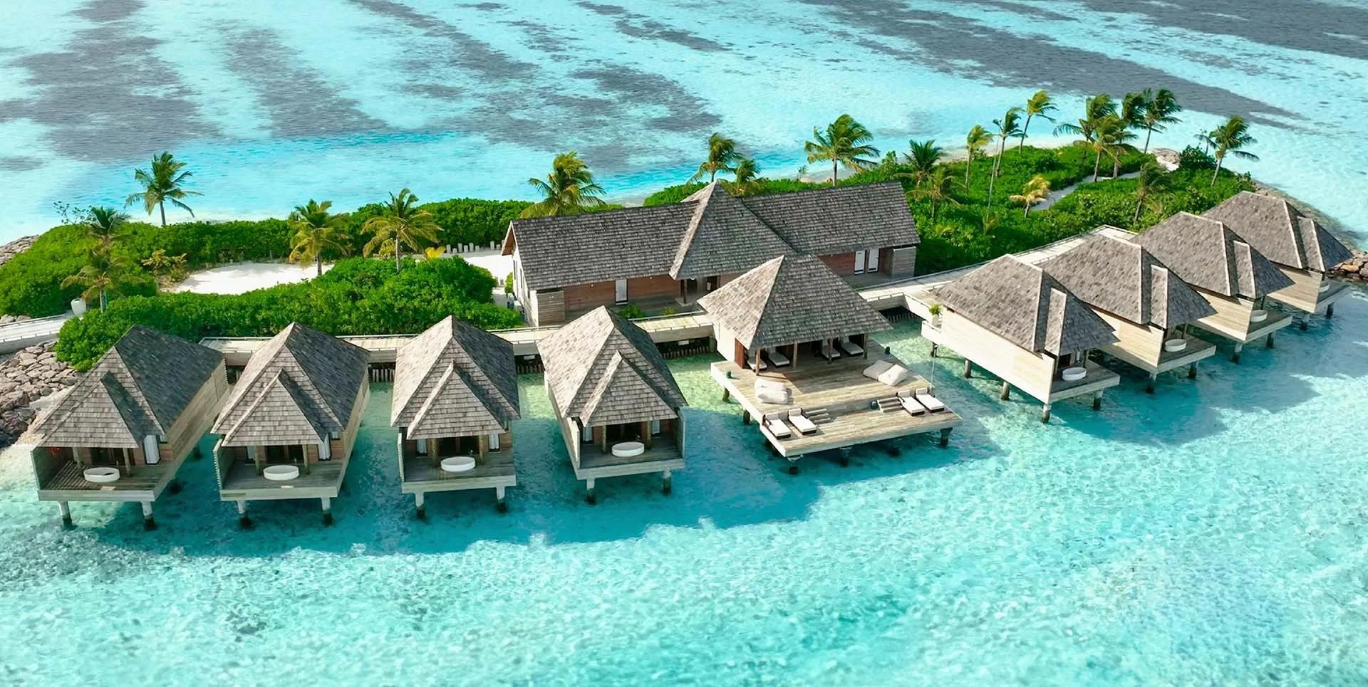 An aerial view of Kuda Villingili Resort Maldives, the spa pavilion set against the reef-fringed lagoon