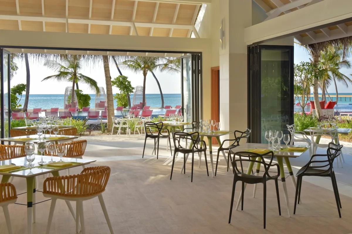 Flavour Zest's open-air dining room, tables set beneath a timber pergola roof