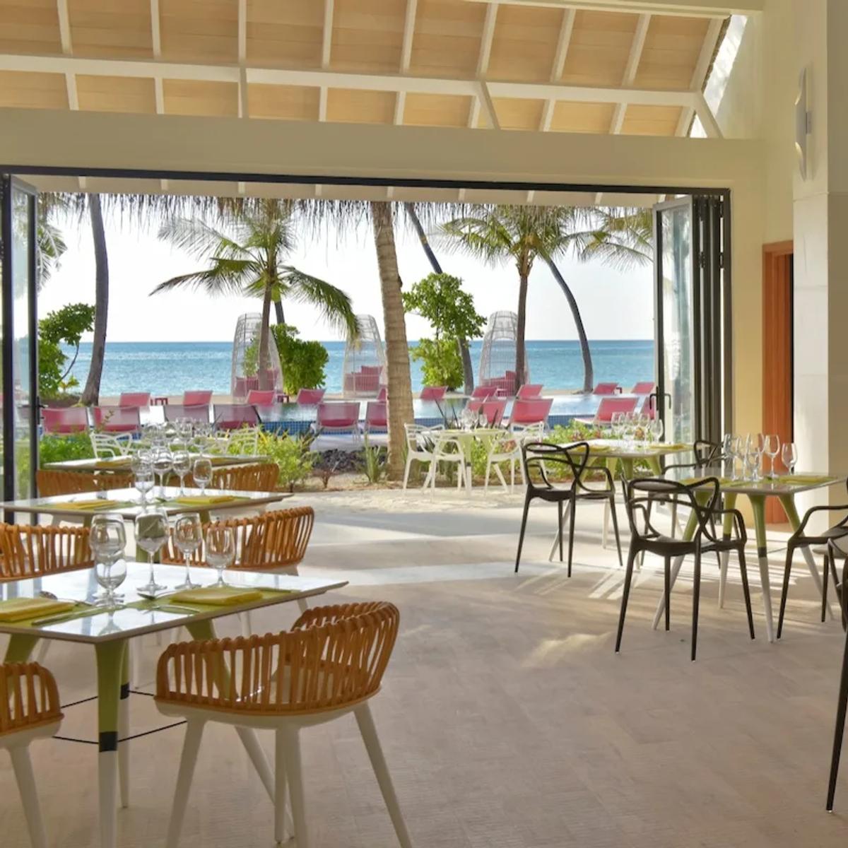 Flavour Zest's open-air dining room, tables set beneath a timber pergola roof