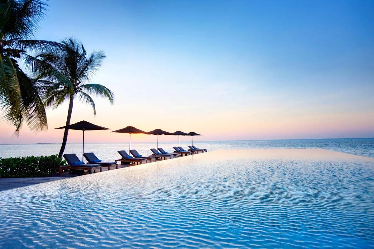 Senses Lounge and Bar's infinity pool and loungers at sunset
