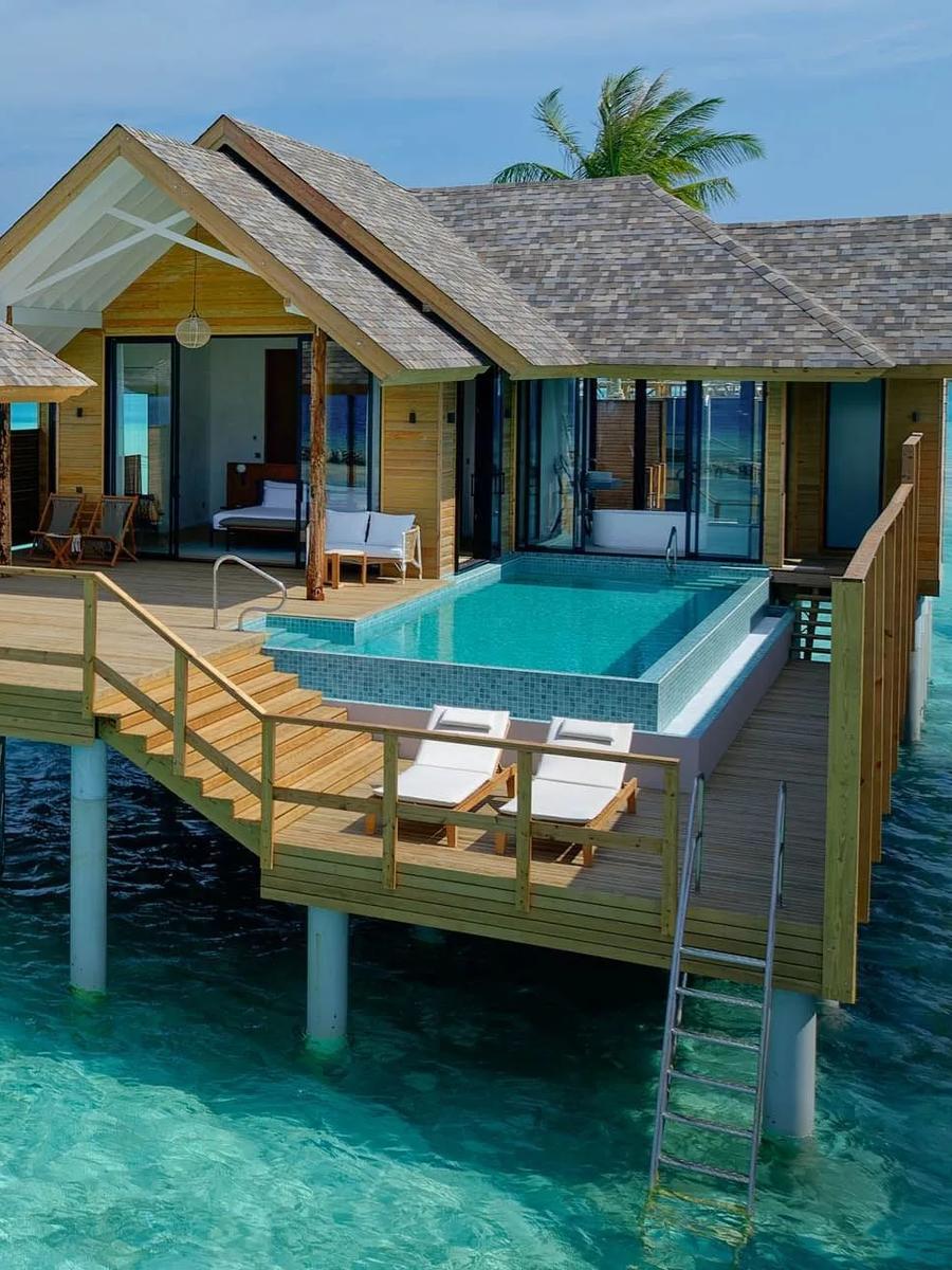 A Deluxe Water Pool Villa's infinity pool and deck, raised over the lagoon