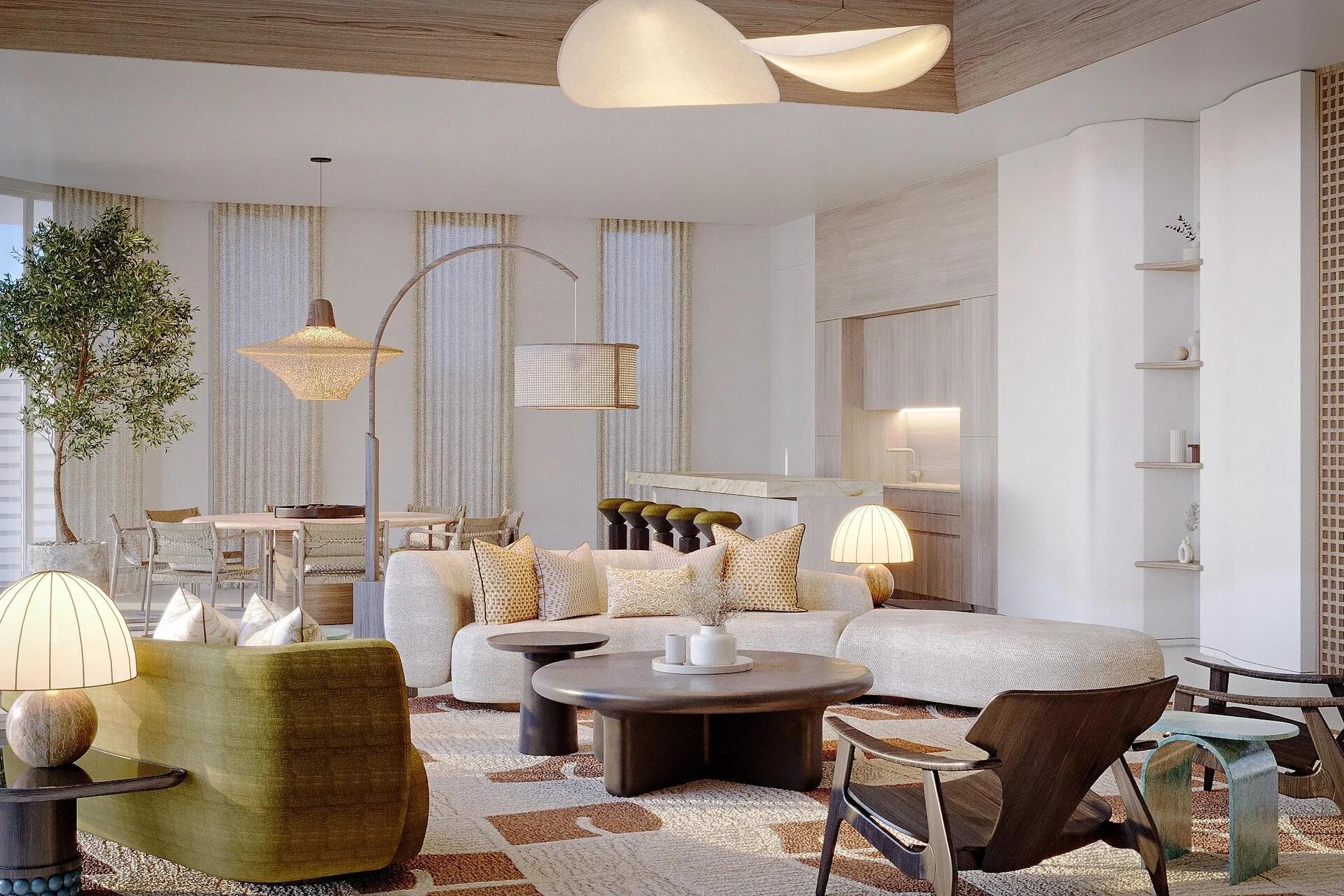 An open-plan living, dining and kitchen area inside a Three Bedroom Sunset Water Retreat, glass doors open to the sea