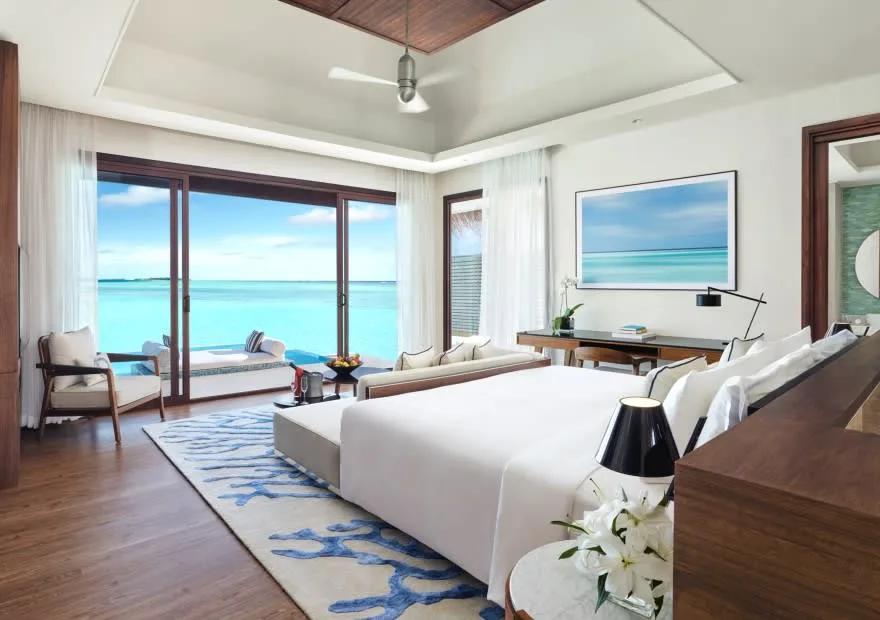 Bedroom interior of an Overwater Villa at Niyama, opening onto the lagoon