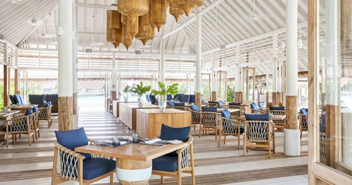 Ufaa, COMO Cocoa Island's restaurant, with woven rattan pendant lights hung over open-air dining tables