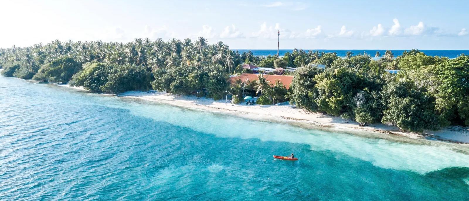 Maldives local island aerial view showing coconut palms and lagoon