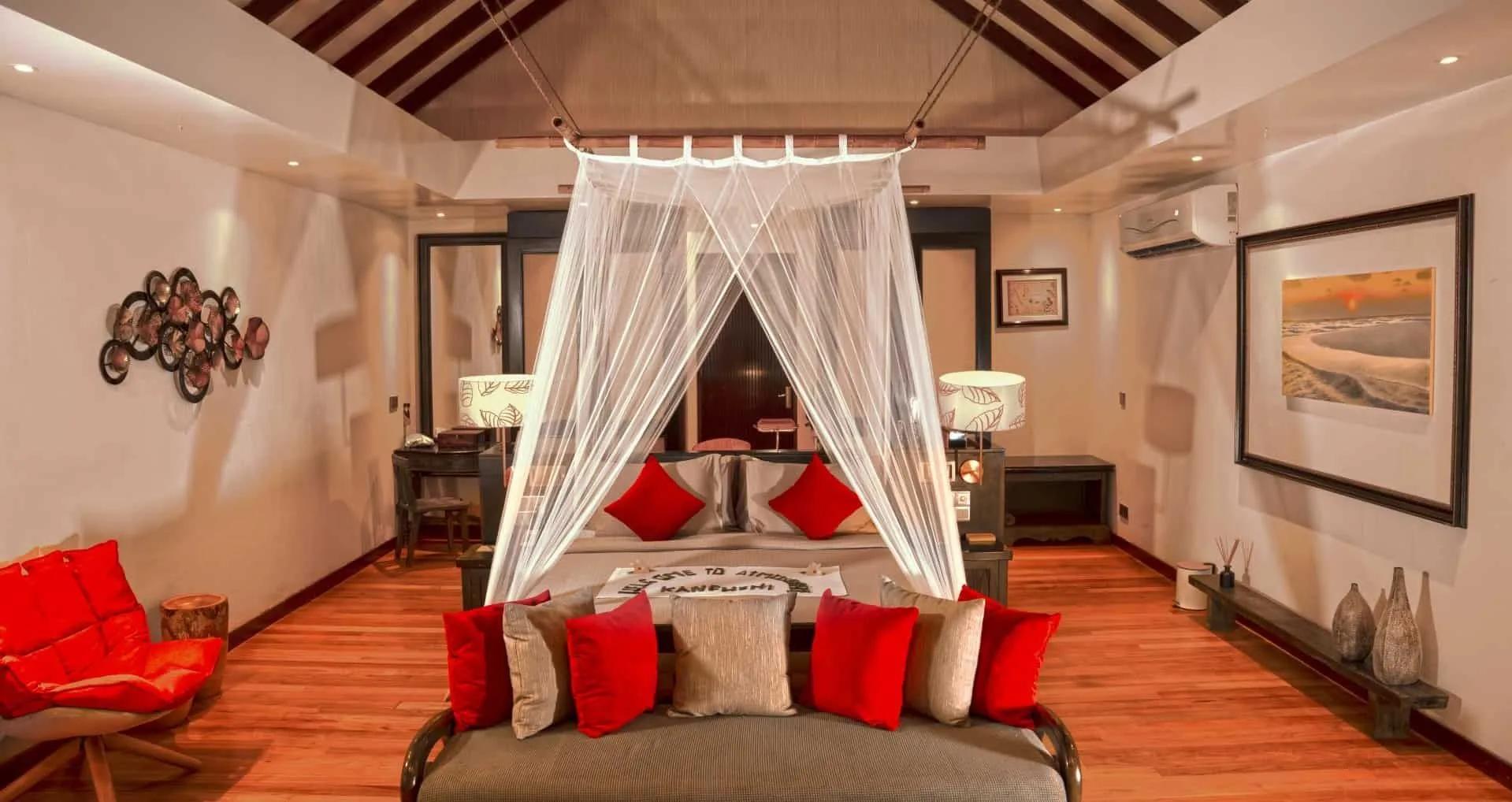 A bedroom inside a two-bedroom family beach villa, netting canopy over the bed — shared research photography with the pool-equipped sibling category, since the official site doesn't split its gallery by variant