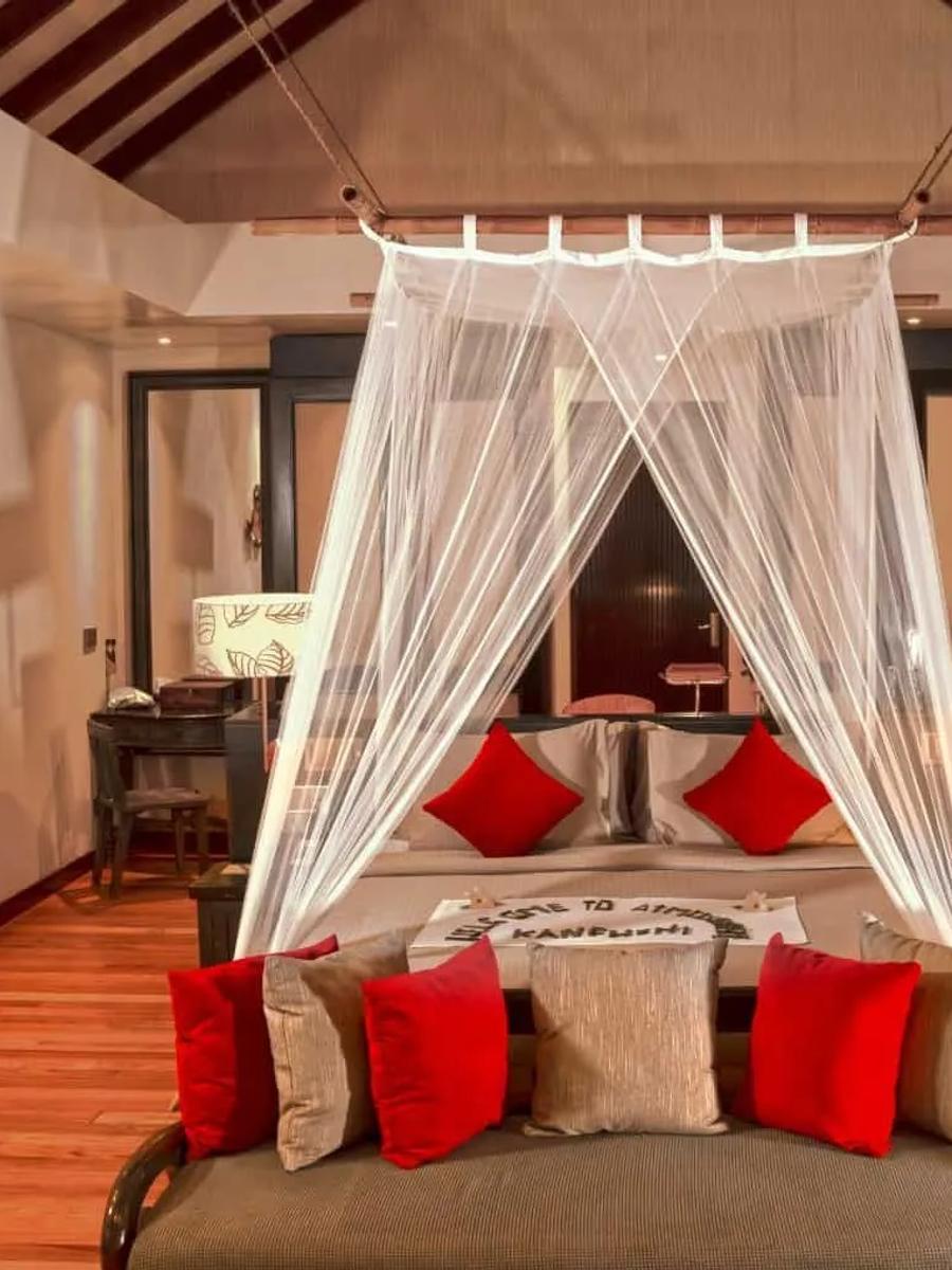 A bedroom inside a two-bedroom family beach villa, netting canopy over the bed — shared research photography with the pool-equipped sibling category, since the official site doesn't split its gallery by variant