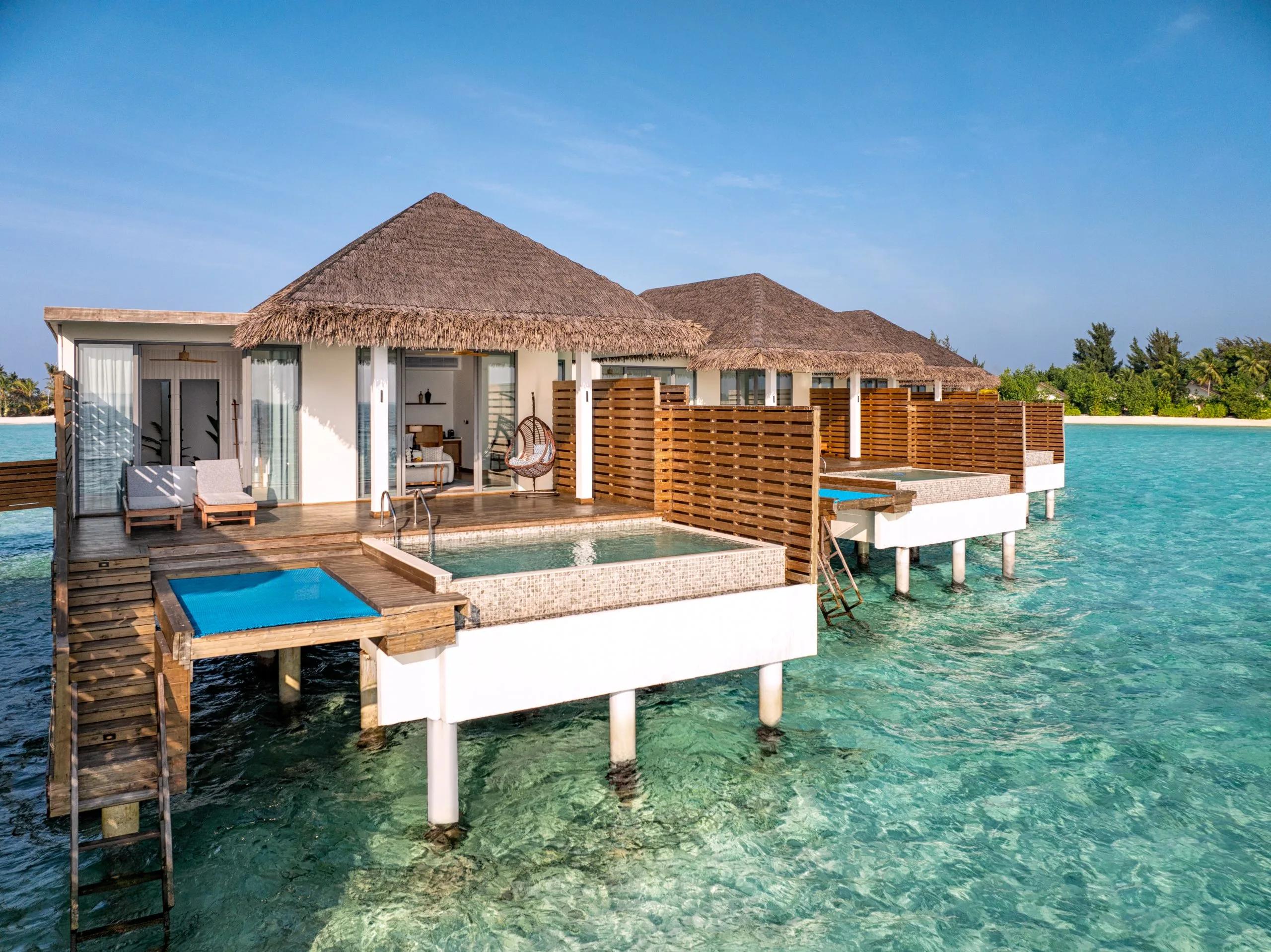An Overwater Pool Villa at dusitD2 Feydhoo Maldives — a dedicated photograph of the sunset-facing Premium Overwater Pool Villa wasn't published, so this near-identical overwater category stands in as the closest match
