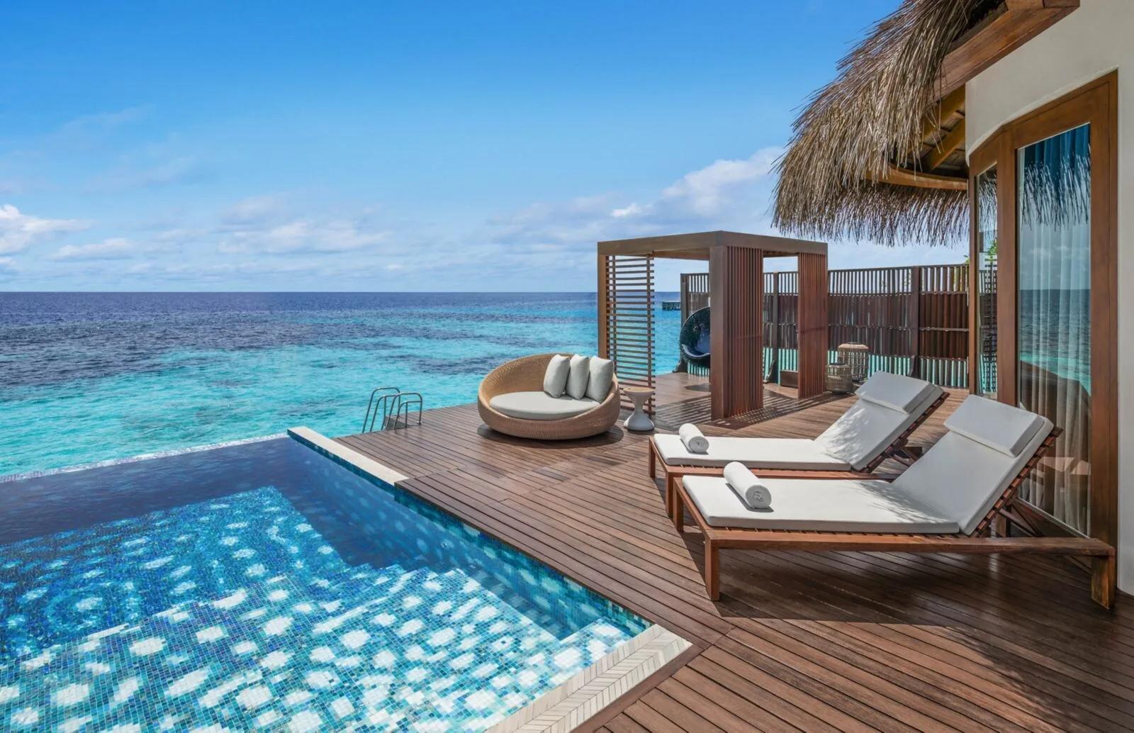 The pool deck of an overwater villa at W Maldives, with a private plunge pool and loungers facing the open ocean — representative of the Premier Overwater category; a dedicated photograph was not available