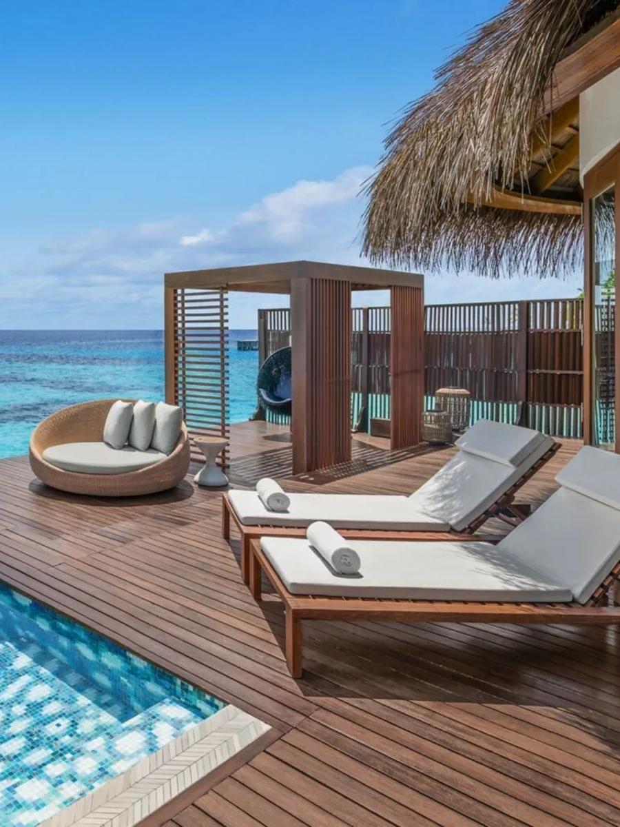 The pool deck of an overwater villa at W Maldives, with a private plunge pool and loungers facing the open ocean — representative of the Premier Overwater category; a dedicated photograph was not available