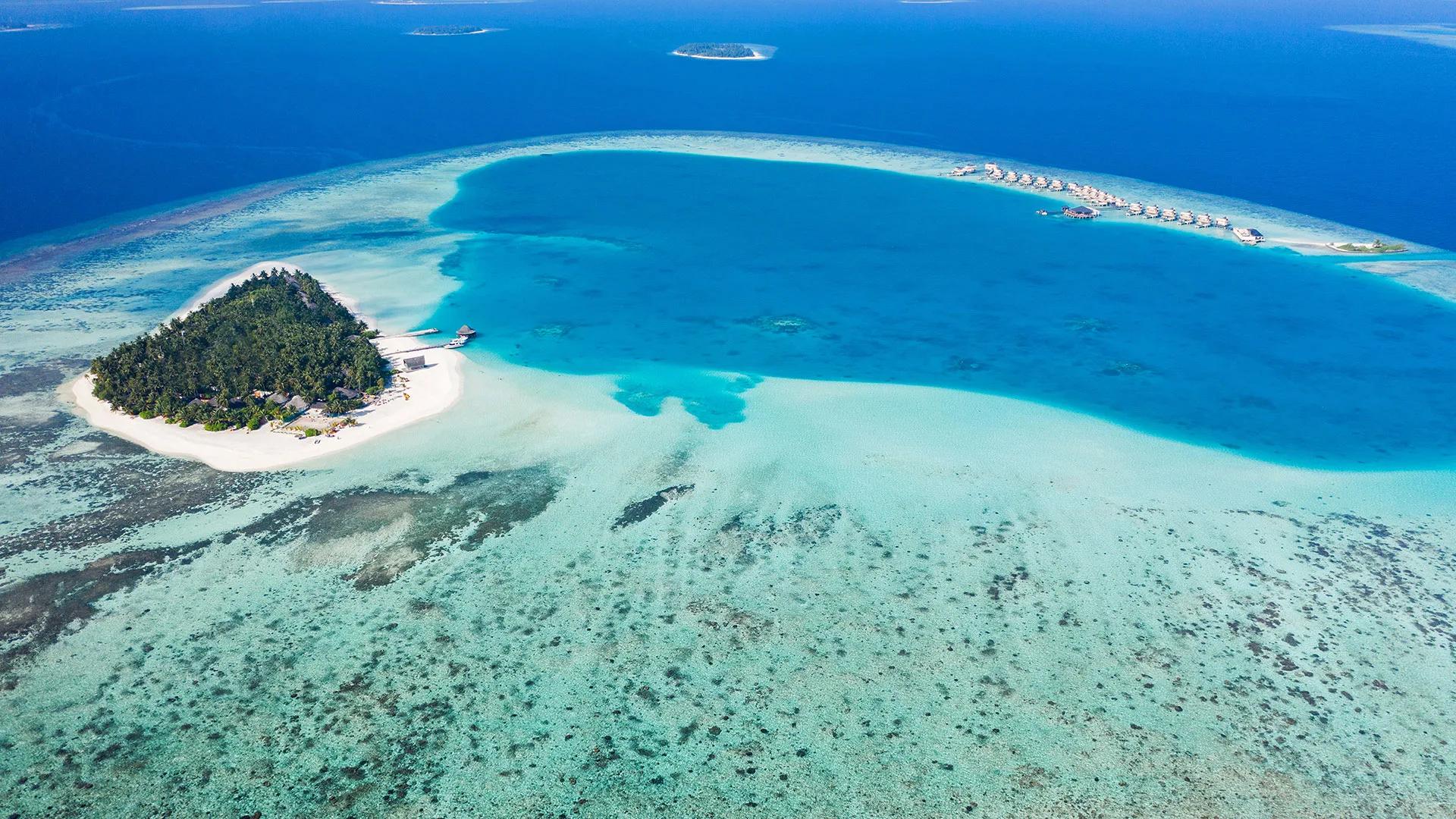 Aerial view of Angsana Velavaru's lagoon and island in South Nilandhe Atoll