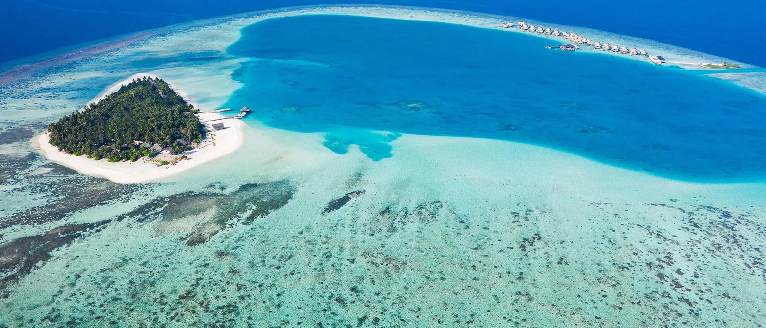 Aerial view of Angsana Velavaru's lagoon and island in South Nilandhe Atoll