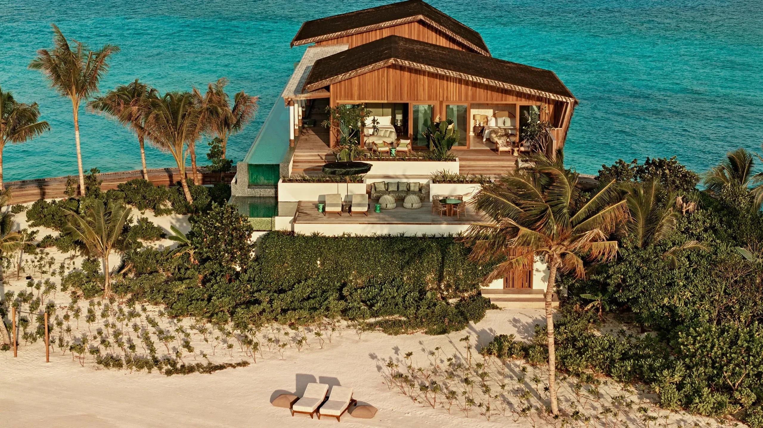 A four-bedroom Somewhere residence at .Here, its private sky pool running along the beachfront deck