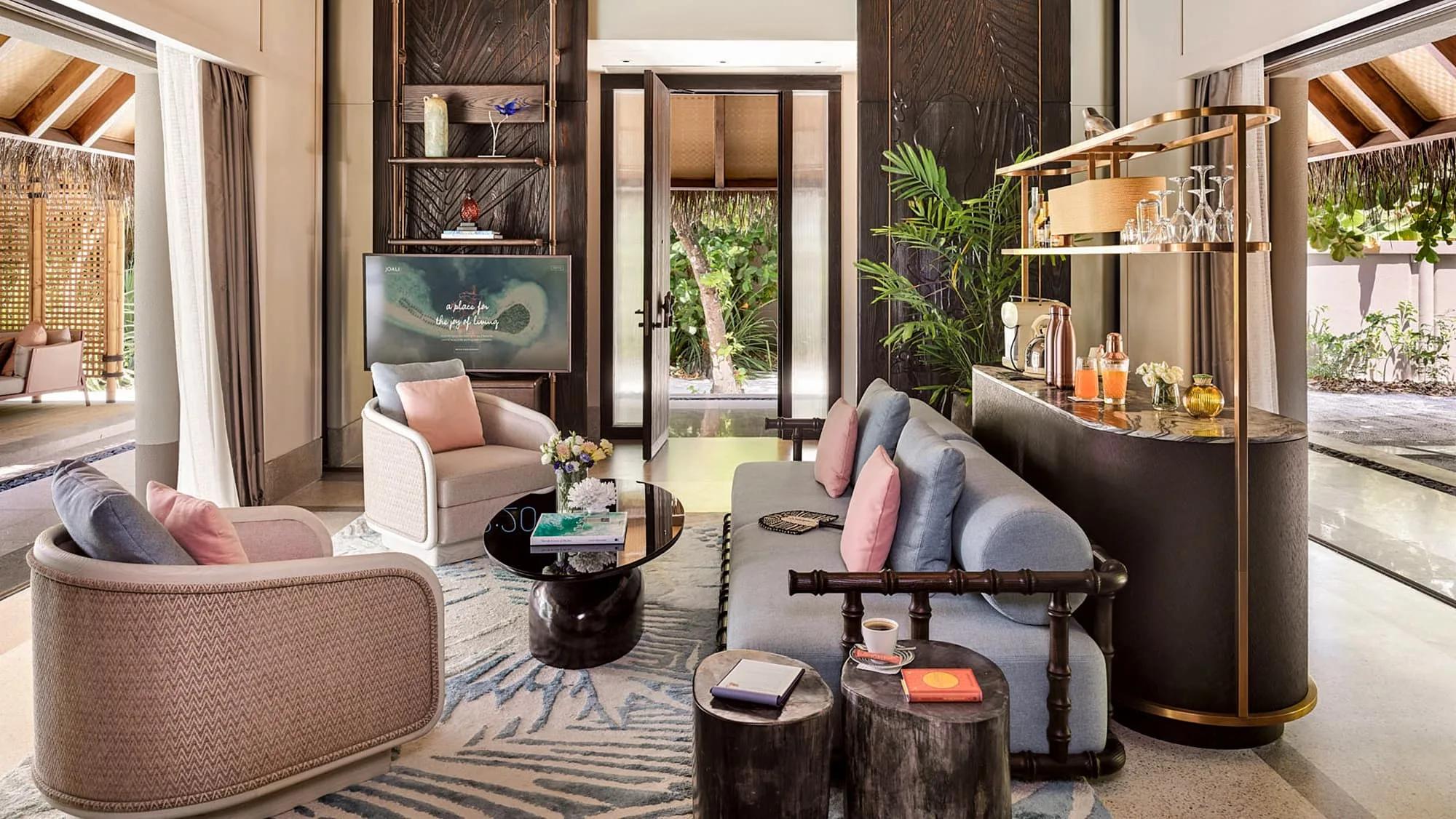 A beach villa's living room opening onto a path through the garden — Two Bedroom Family Beach Villa photograph to follow
