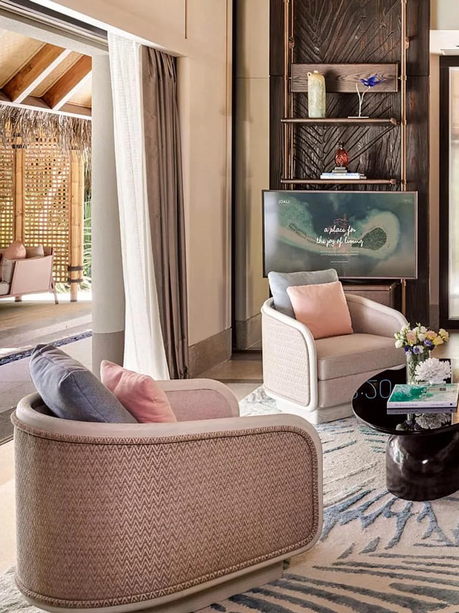 A beach villa's living room opening onto a path through the garden — Two Bedroom Family Beach Villa photograph to follow