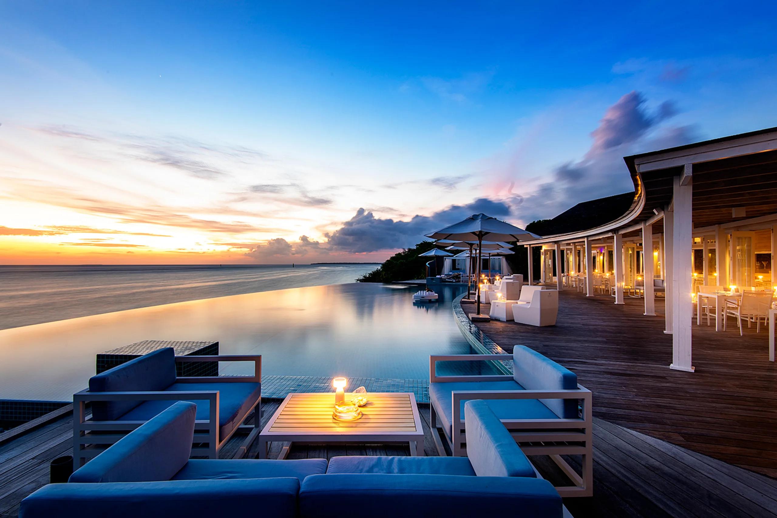 Sunset Pool Café's infinity pool and deck at sunset, Hideaway Beach Resort & Spa