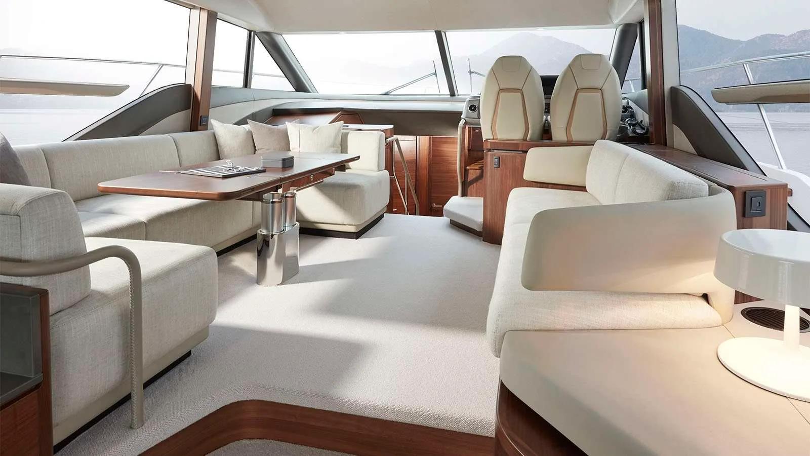 The upholstered saloon and dining table aboard Kudadoo's charter yacht
