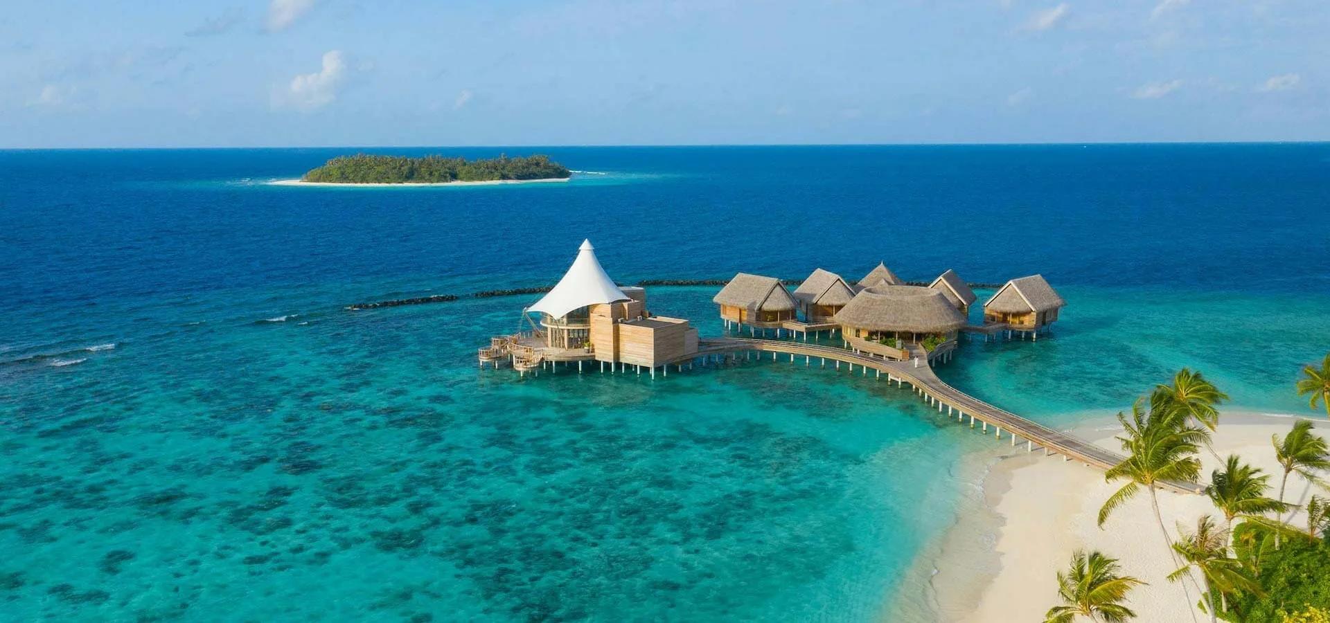 Zeytoun's sail-roofed overwater restaurant, linked to the beach by a long timber walkway.