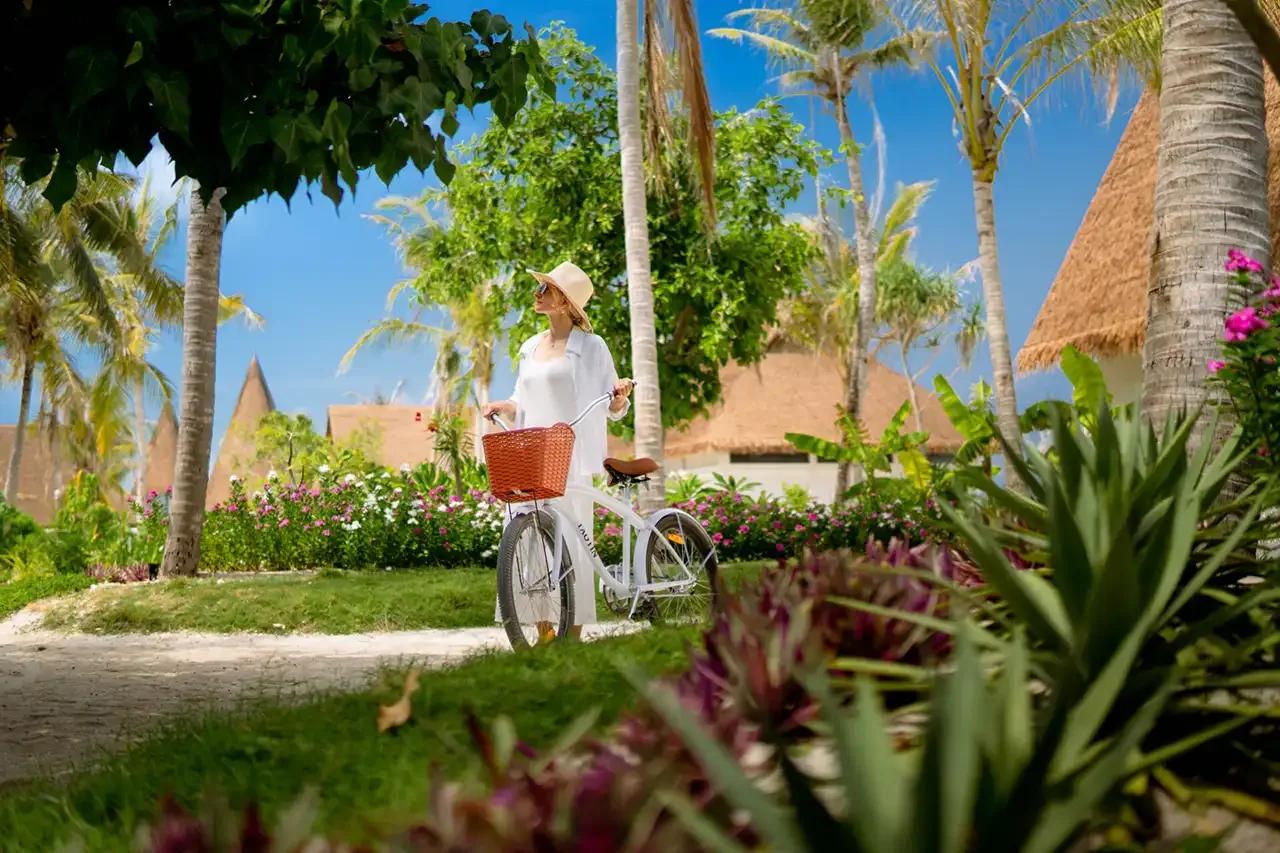 A guest cycling along Meyyafushi's garden paths, one of the island's leisure activities