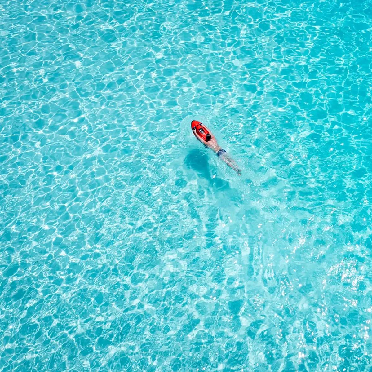 Aerial view of Niva Kurumba Maldives and its surrounding lagoon, the reef edge visible just off the beach