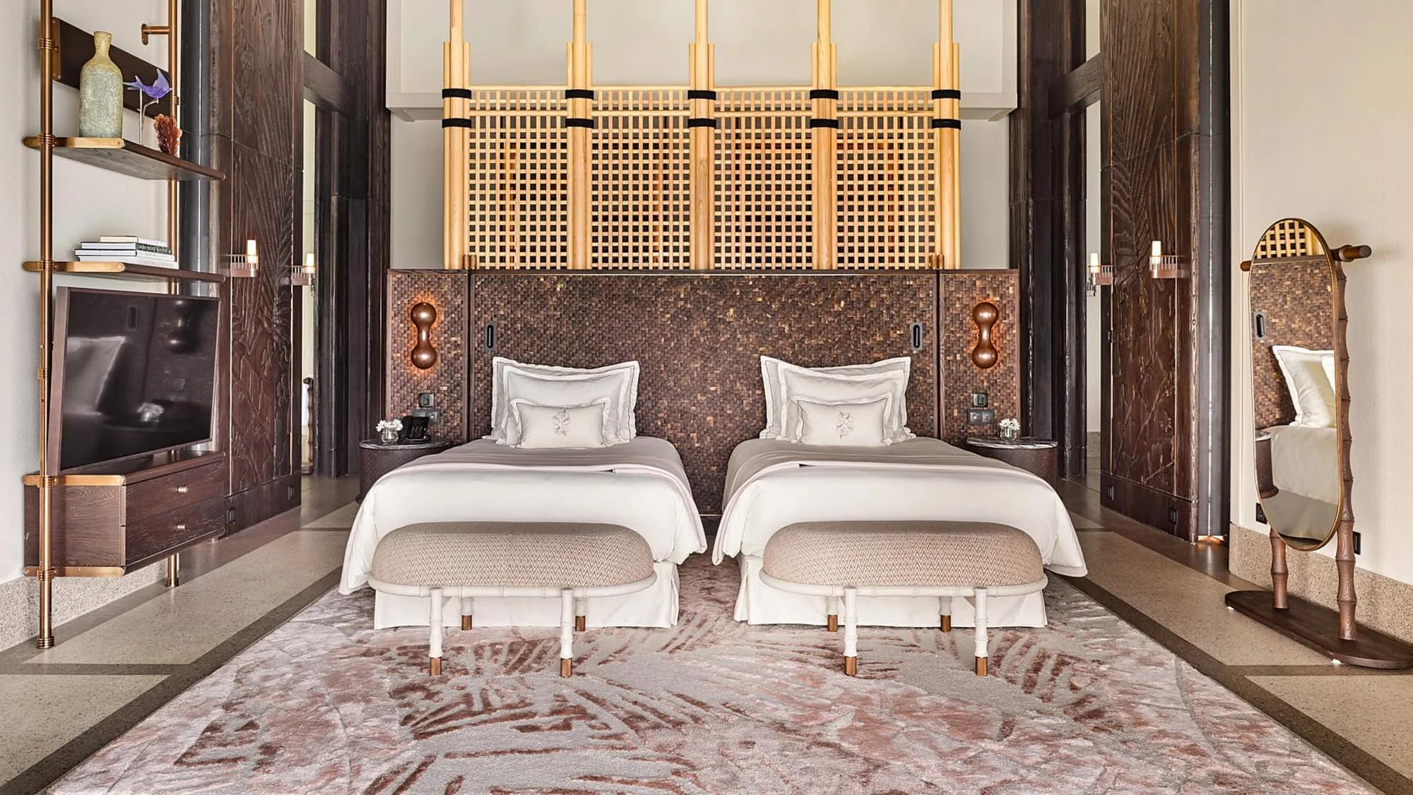 Twin beds with a woven bamboo headboard screen in the Three Bedroom Ocean Residence with Two Pools