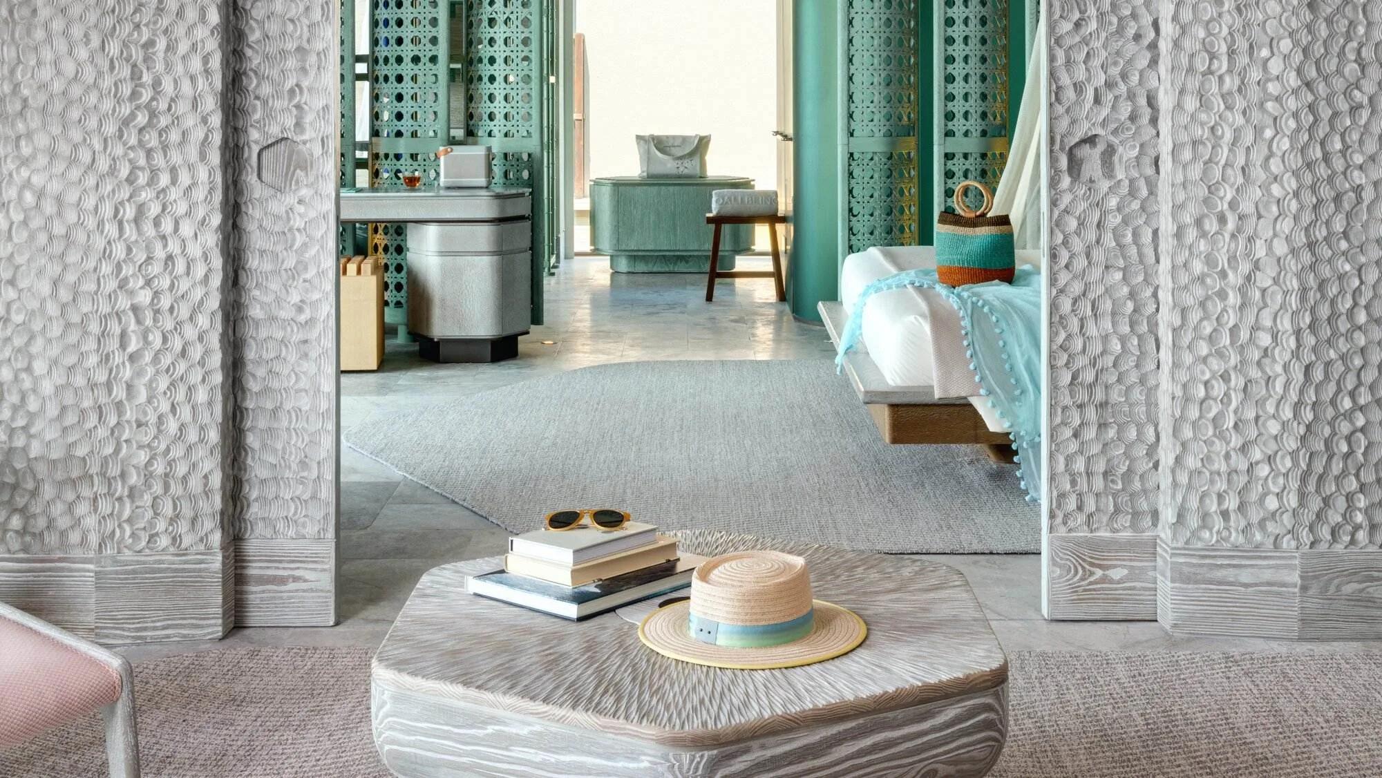 The living room of a Grand Ocean Pool Villa at Joali Being, opening onto the lagoon-facing sundeck