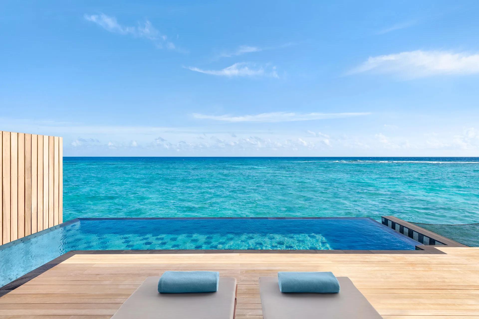 The sundeck and private pool of a One Bedroom Overwater Pool Villa, set over the lagoon