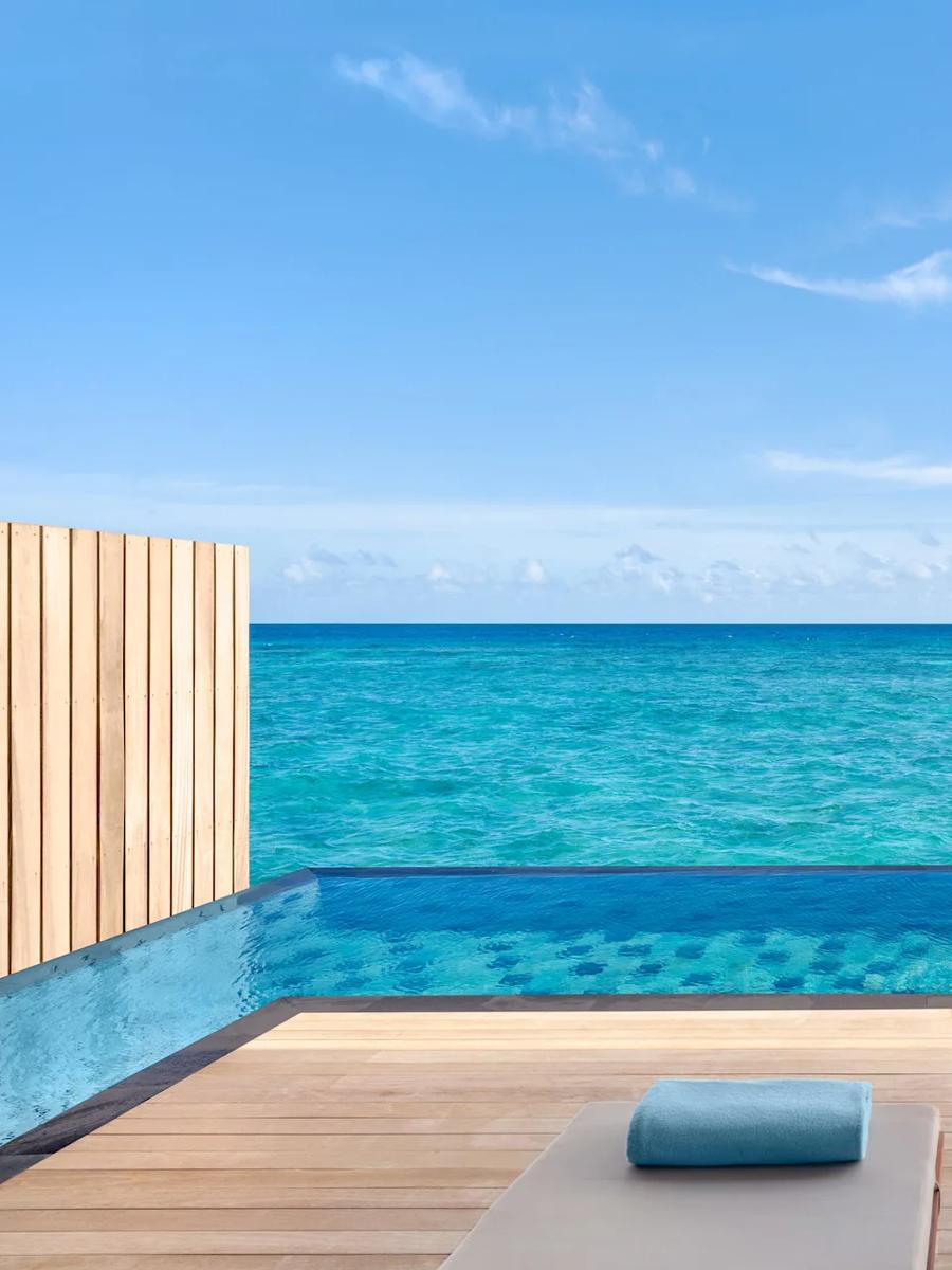 The sundeck and private pool of a One Bedroom Overwater Pool Villa, set over the lagoon