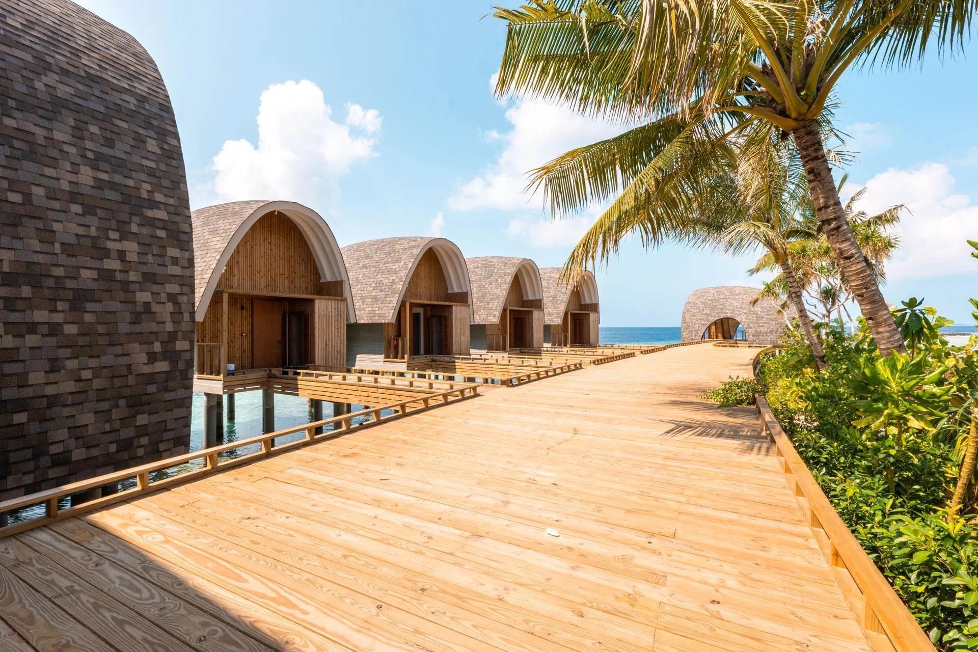 Kandu Spa's overwater treatment pavilions, arched shingled roofs stepping out along the water