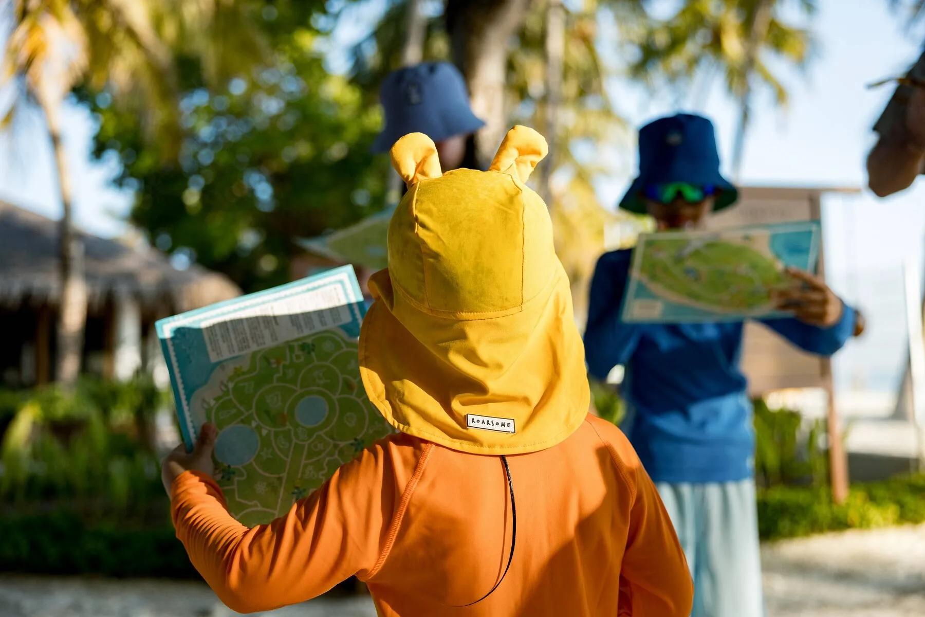 Children in costume following an island treasure map during the ROARSOME Treasure Hunt at Majaa Explorers Club