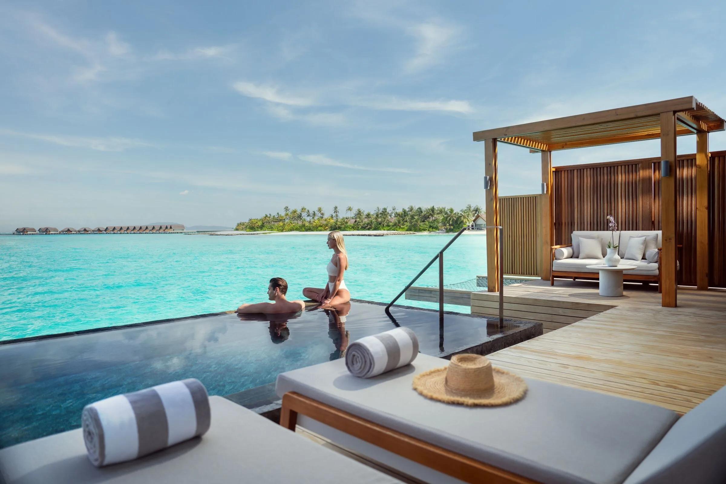 A couple relaxing in the private pool of a Beach Pool Villa
