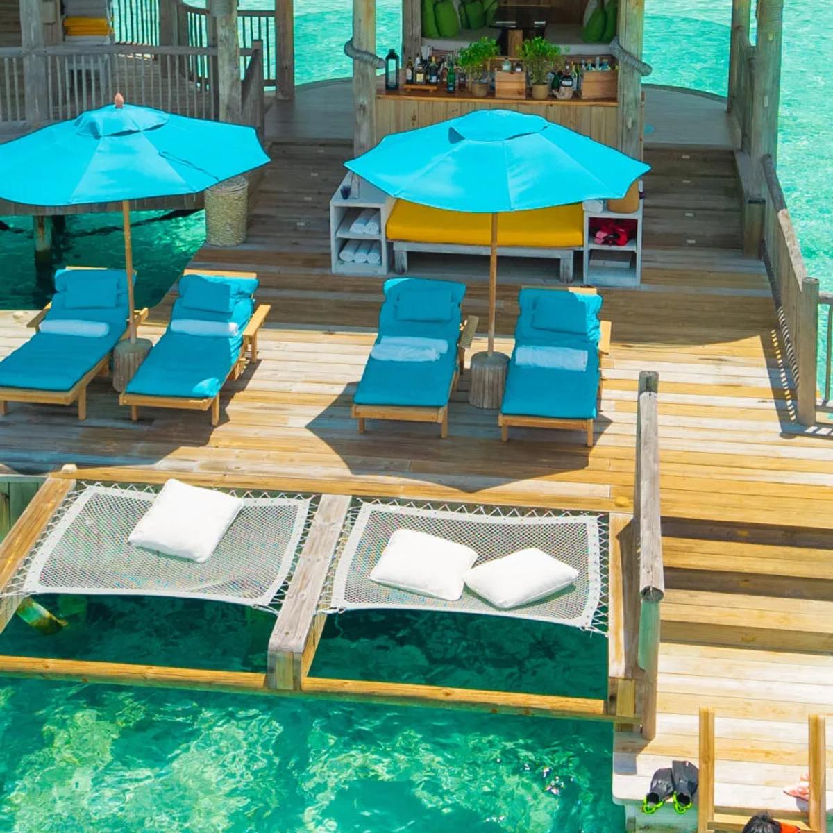 The elevated, open-air lounge deck at Director's Cut, Soneva Jani's Japanese restaurant, set above the lagoon