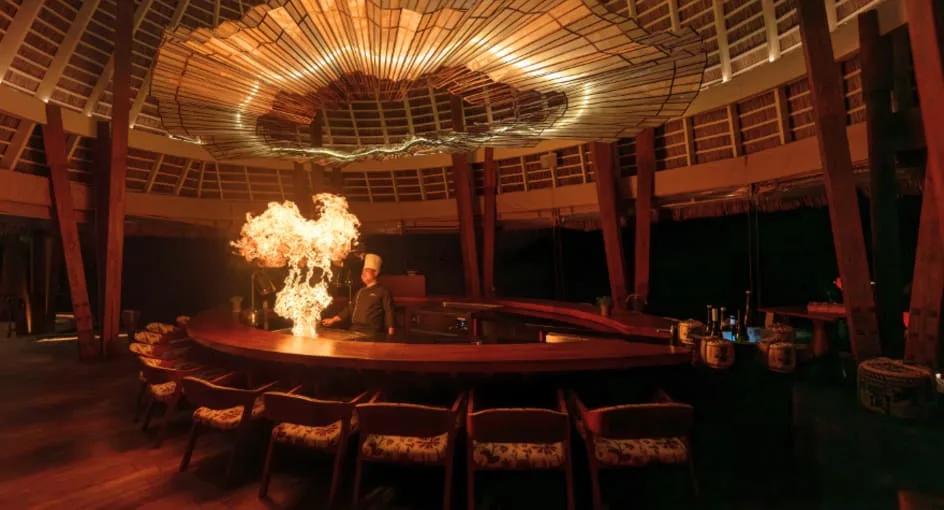 FIRE restaurant's overwater dining room at Anantara Kihavah Maldives Villas