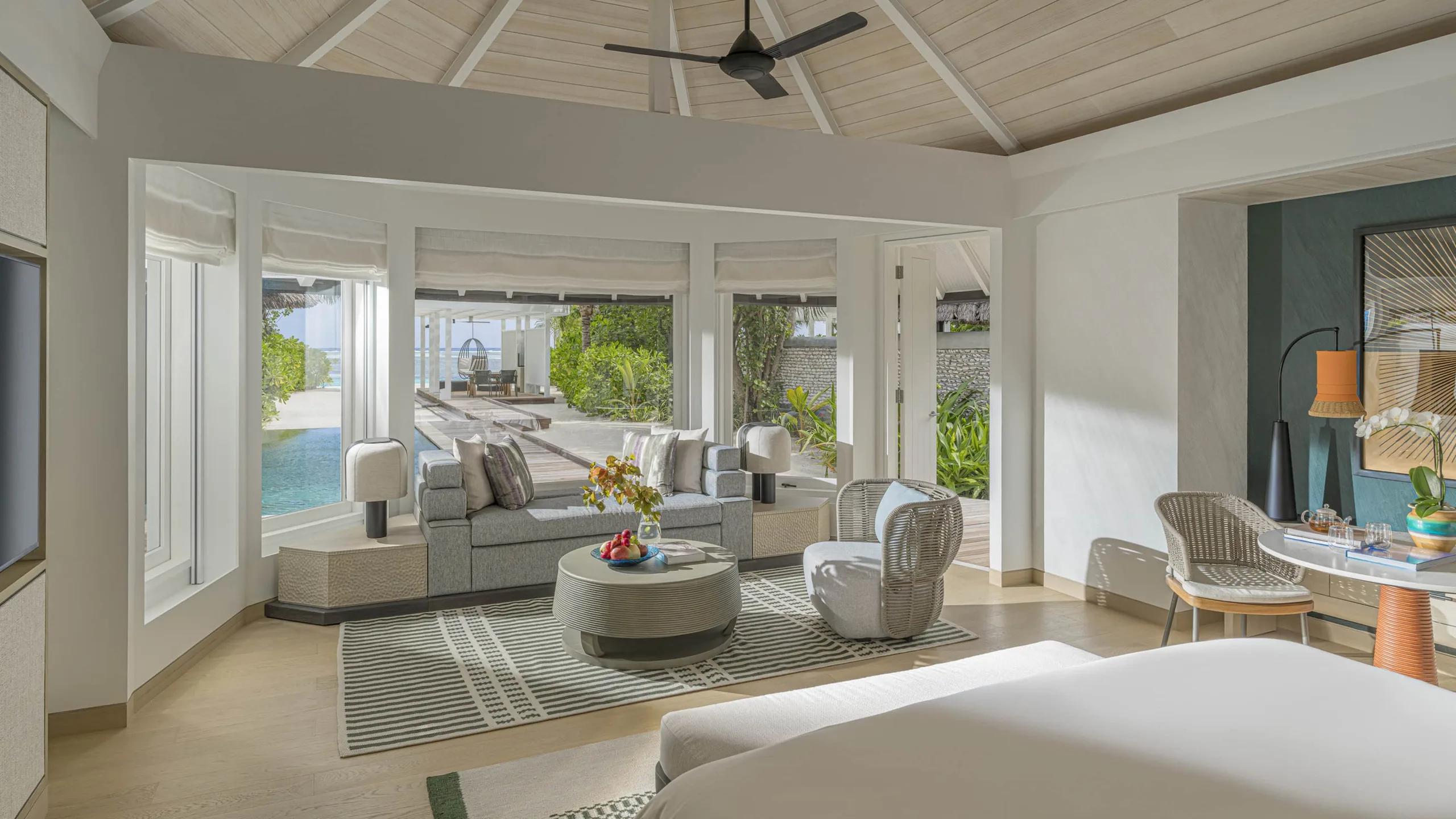 A Sunset Family Beach Villa's living room, opening onto the pool deck and lagoon