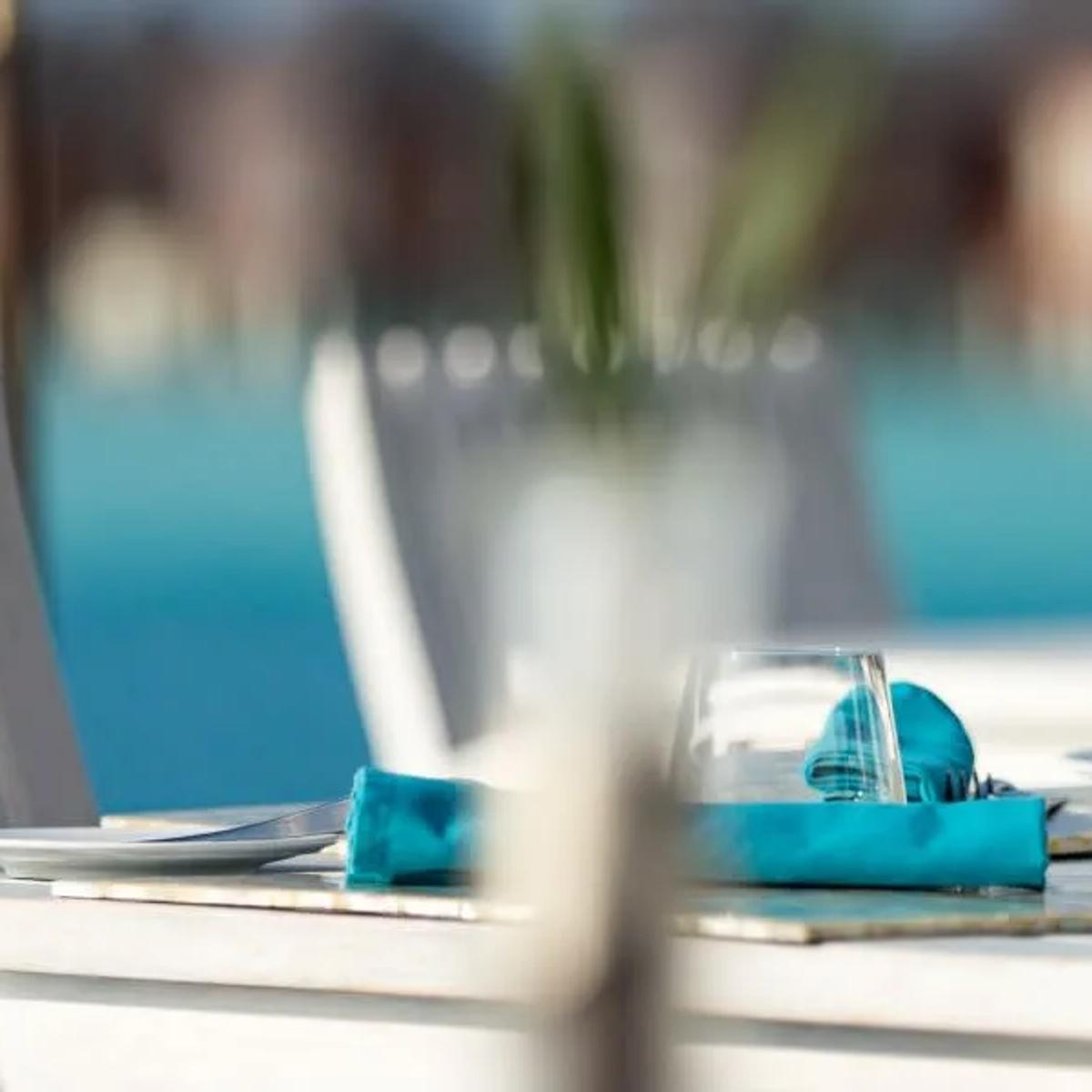 A table set for a meal at Sea.Fire.Salt., overlooking the lagoon