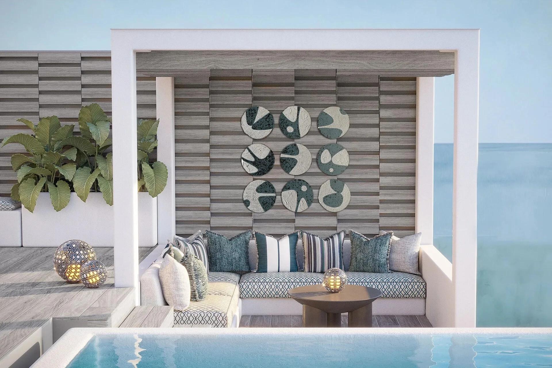 A shaded rooftop lounge on a Lagoon Villa's terrace, with a nine-piece ceramic wall installation above a built-in sofa
