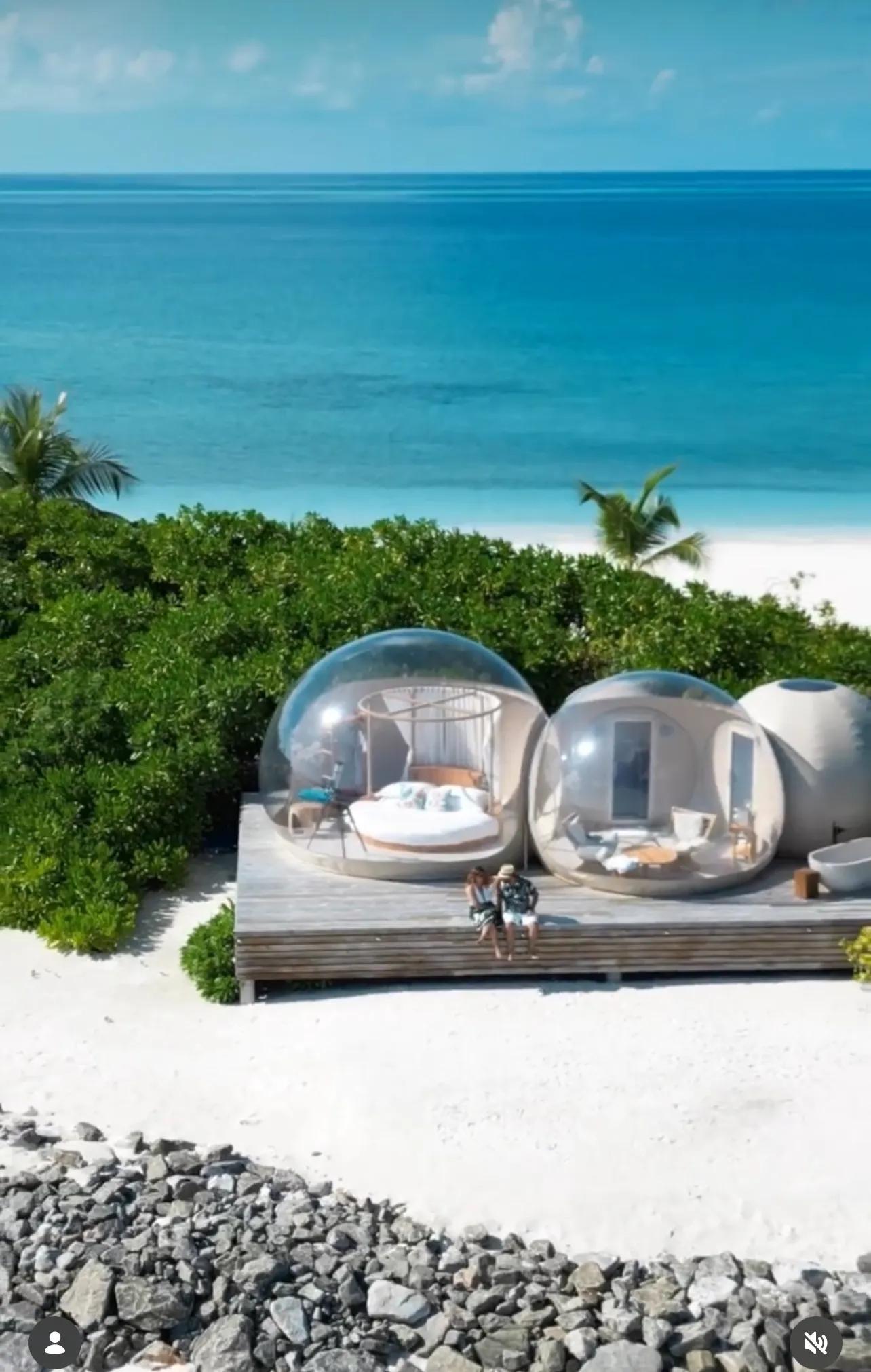 A couple photographed at the water's edge of a Maldives island