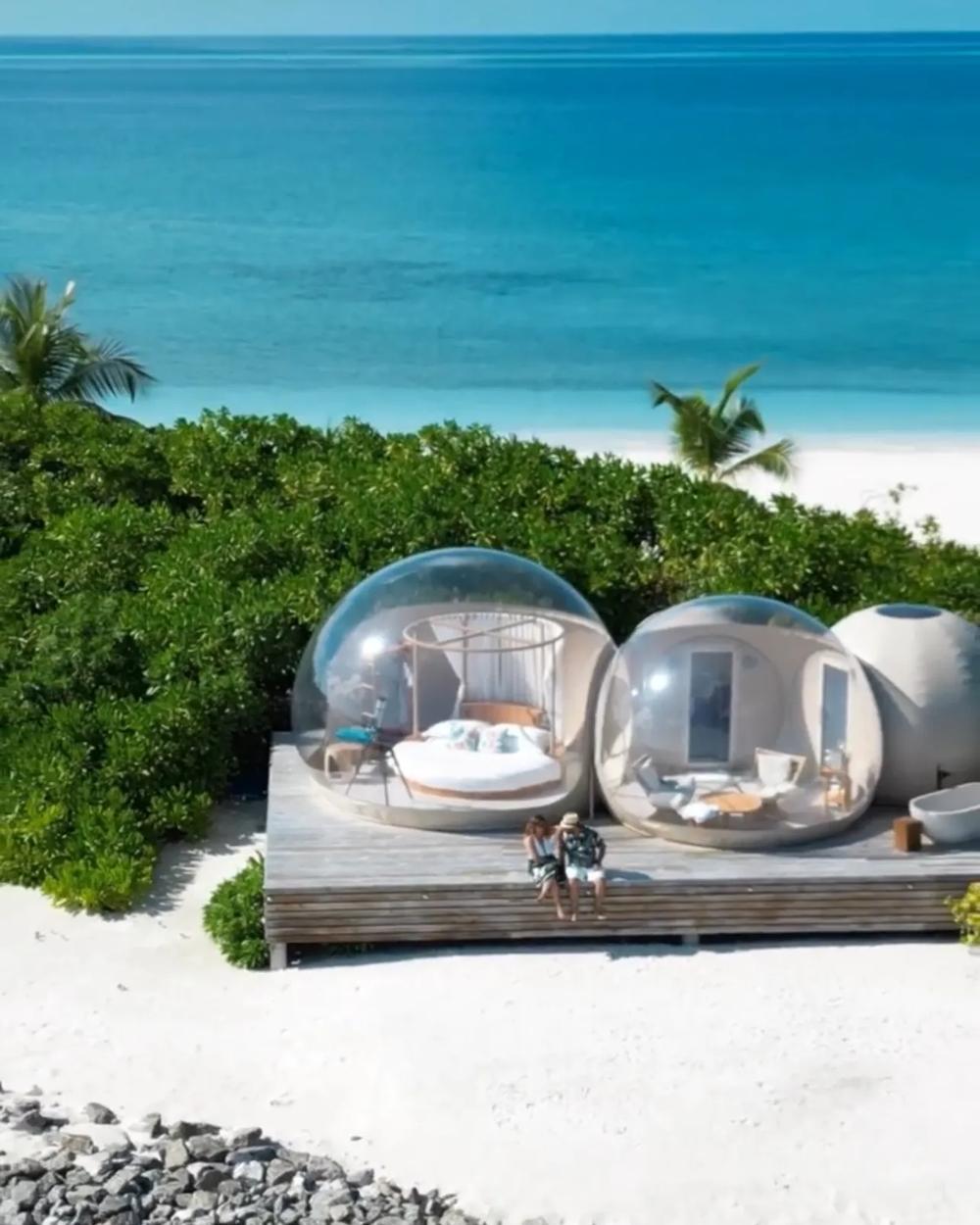 A couple photographed at the water's edge of a Maldives island