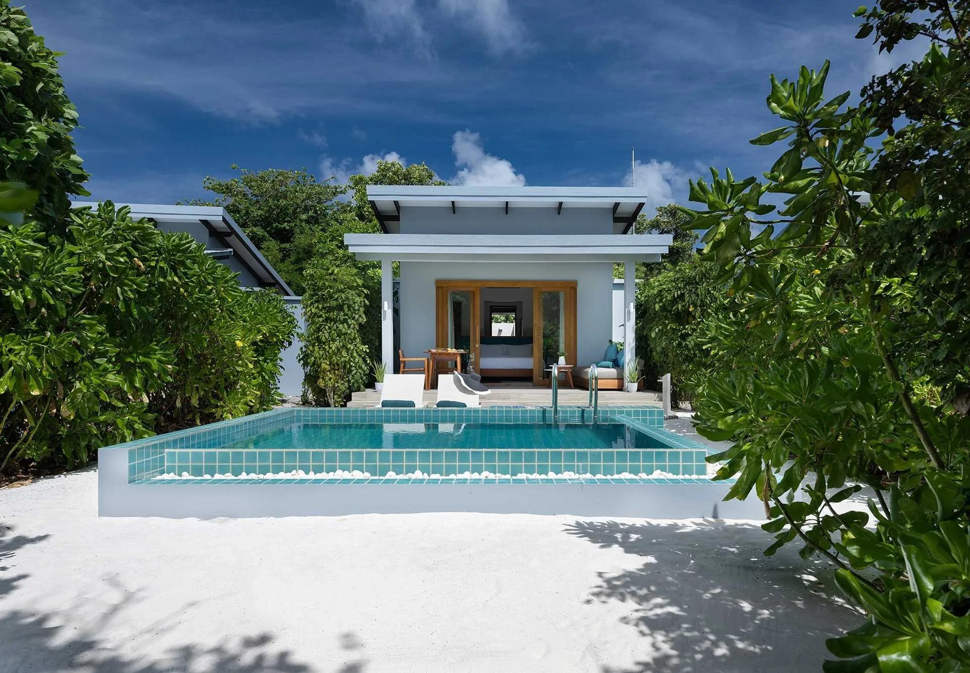 The exterior and private pool of a Sunset Beach Villa with Pool at Ifuru Island Maldives