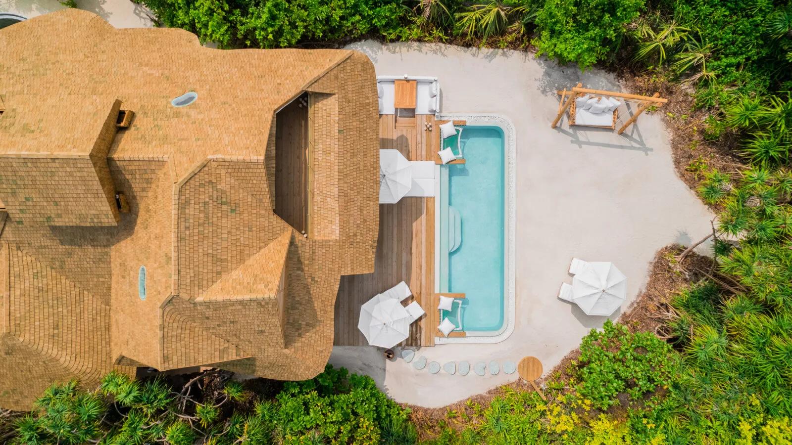 The Beach Hideaway villa at Soneva Jani, its pool and deck set behind the beach