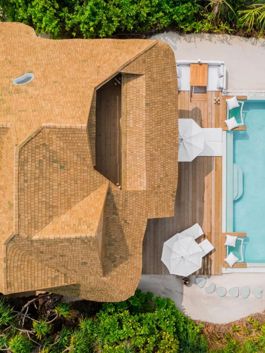 The Beach Hideaway villa at Soneva Jani, its pool and deck set behind the beach