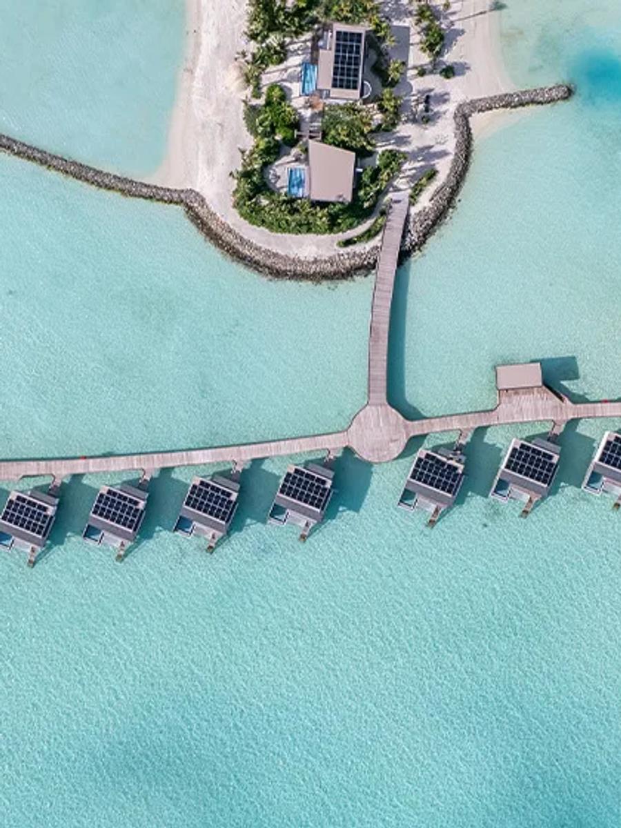 Aerial view of SO/ Maldives' overwater villa jetties by day — representative of the Three-Bedroom Ocean Water Pool Atelier; a dedicated photograph was not available